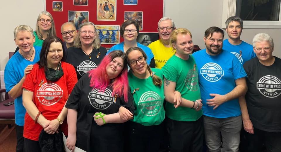 The choir in colourful Sing with Pride T-shirts just before concert